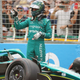 A photo of Lance Stroll and his crashed Aston Martin F1 car.